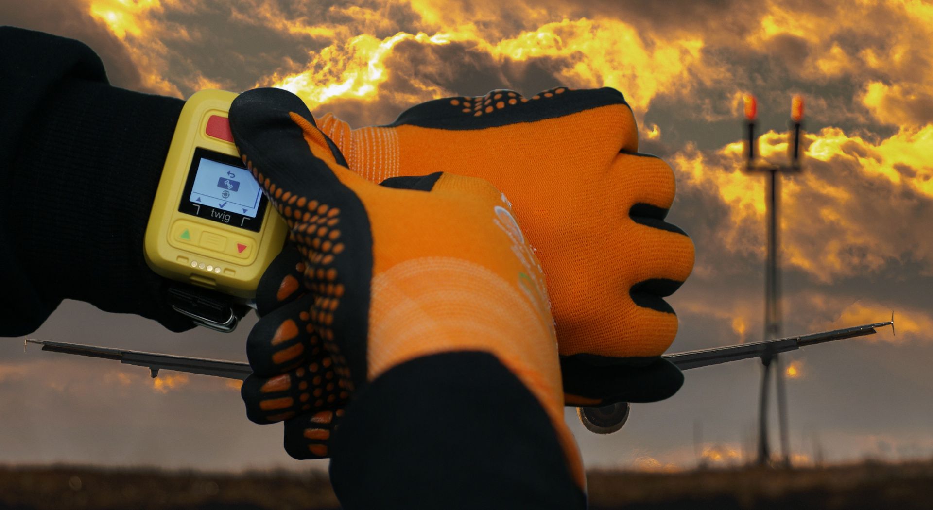TWIG Neo Ex on wrist with gloves and airport background